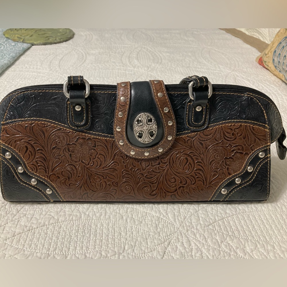 M.C. Tooled and studded leather handbag. Well used but in beautiful condition.